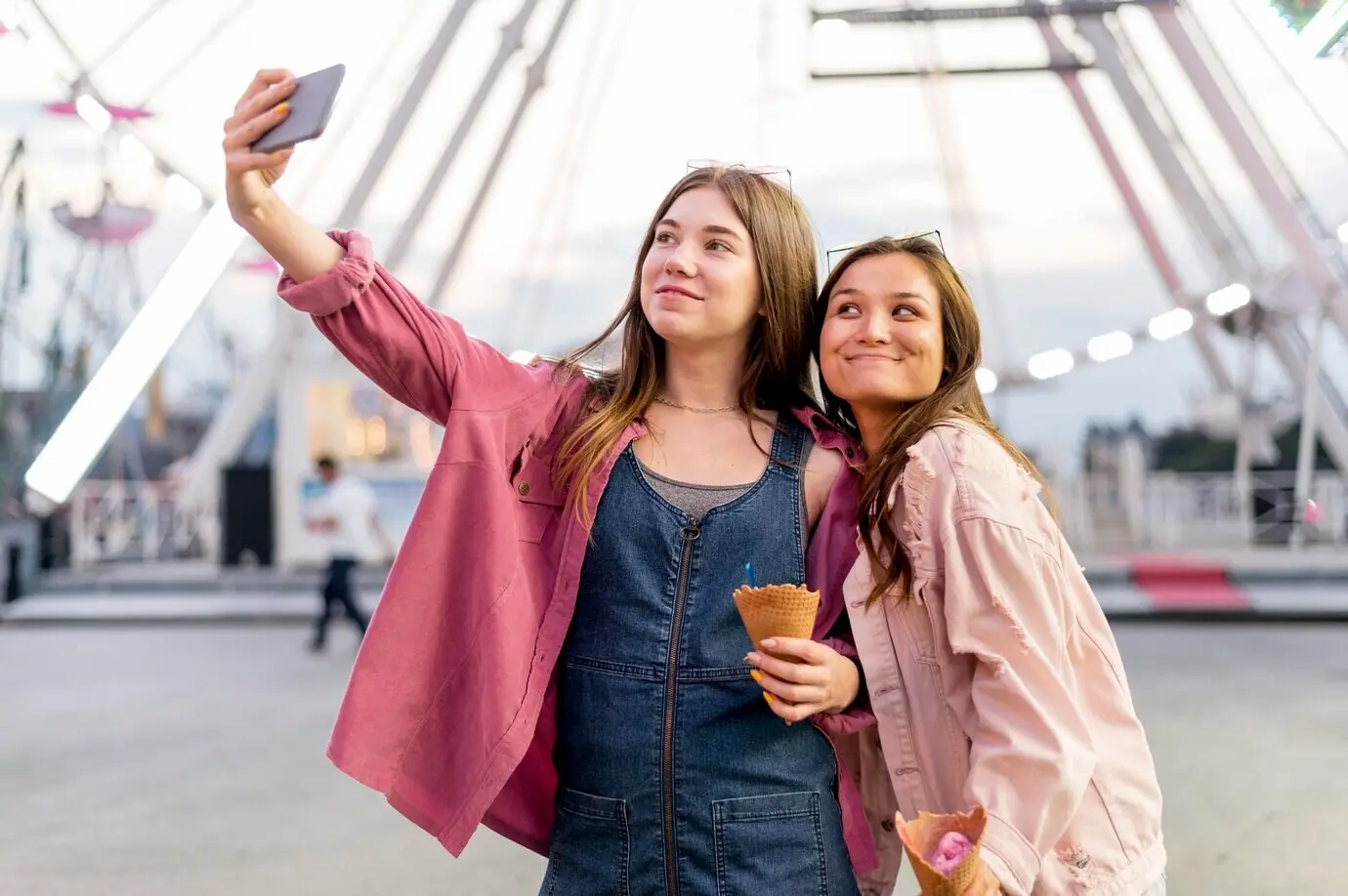 Women are taking a selfie together.